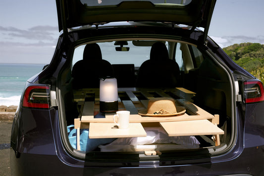 Teraglide platform bed setup inside a car trunk, showing a cozy, organized camping space ready for sleep