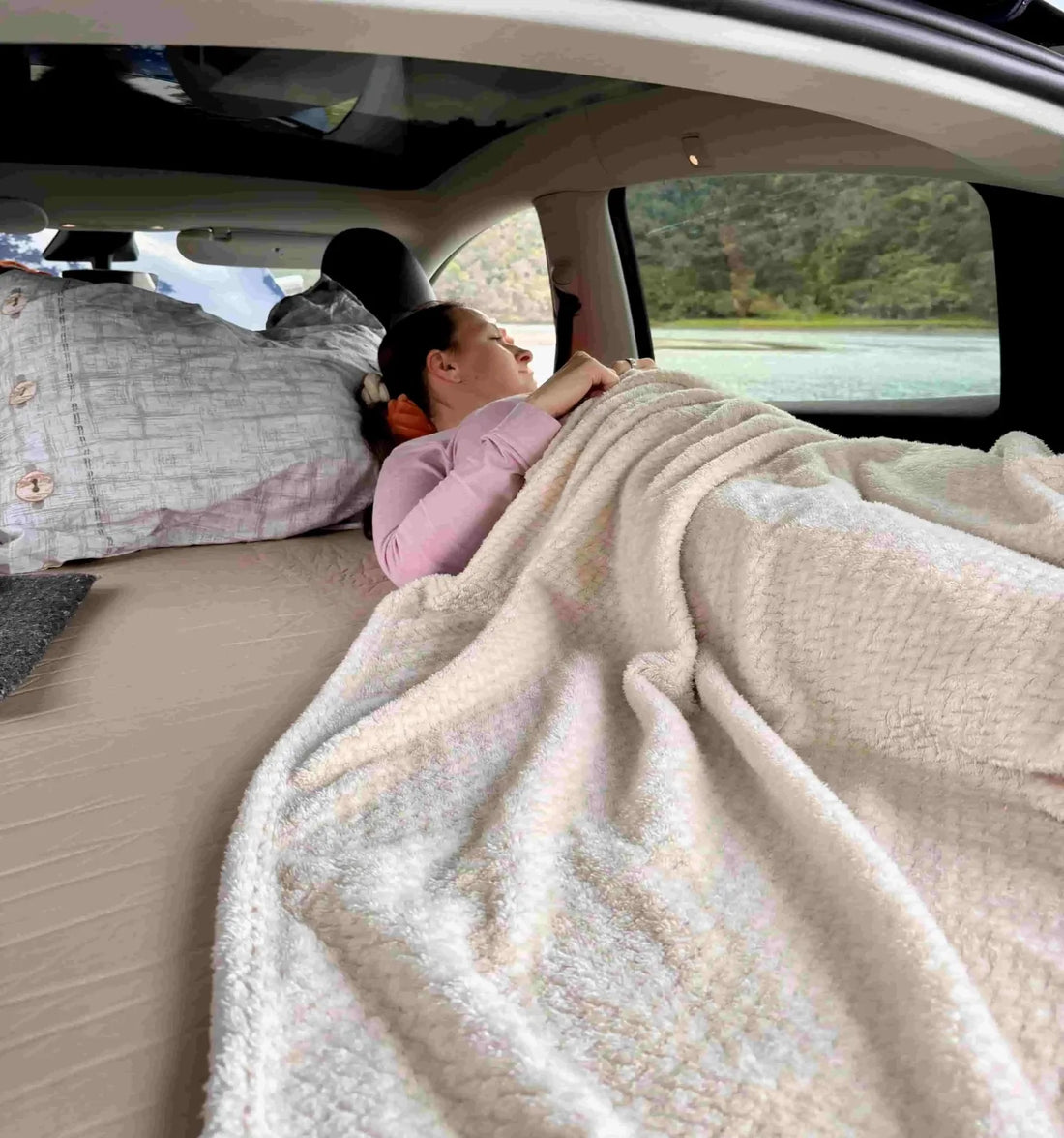 Inside Tesla setup with Teraglide camping bed and Camp Mode running, safe sleep with windows closed