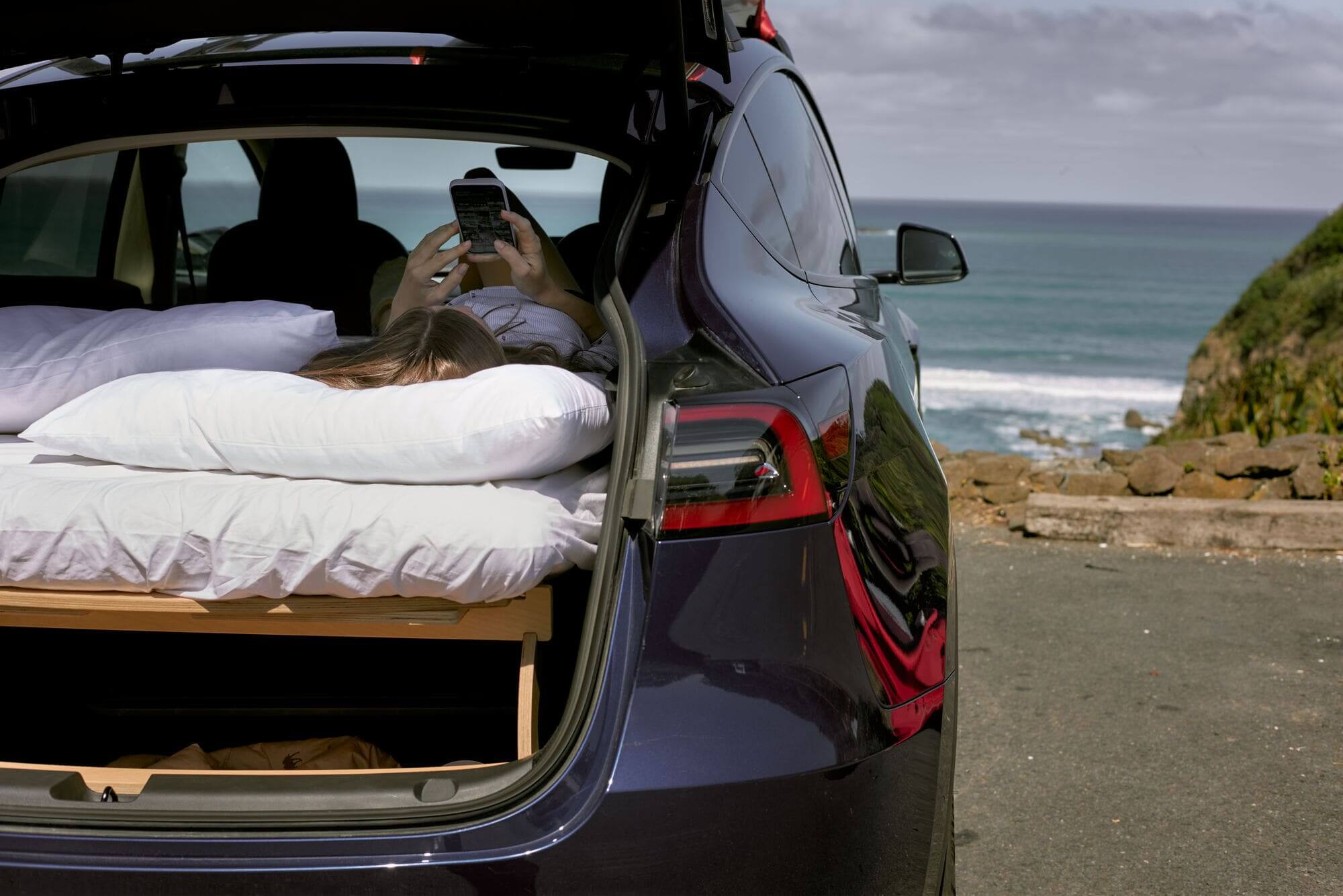 Woman enjoy camping in the car