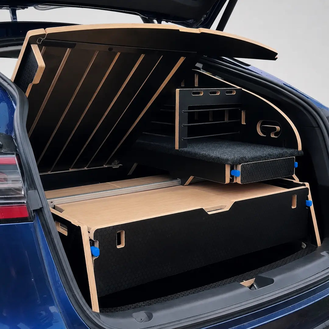 Lift-up sleeping platform on the Teraglide SOLO for easy access to the Tesla Model Y subtrunk and additional storage.
