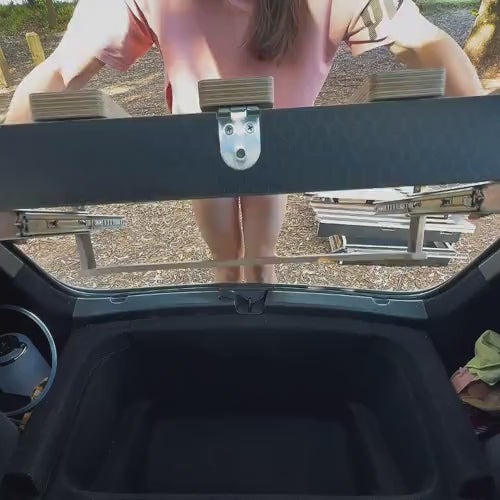 Woman loading the Teraglide PRO platform into a Tesla Model Y trunk by herself