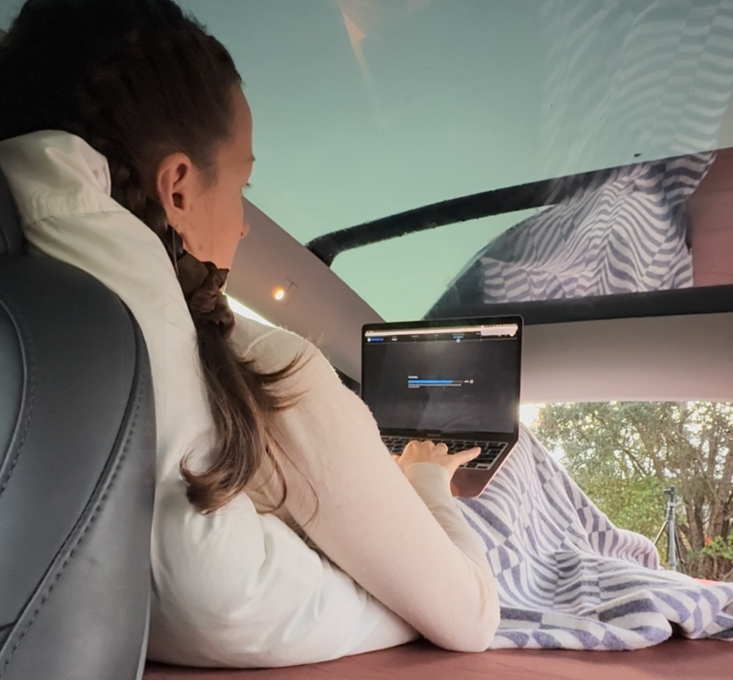 Tesla Model Y parked with Teraglide platform used as mobile office and bed