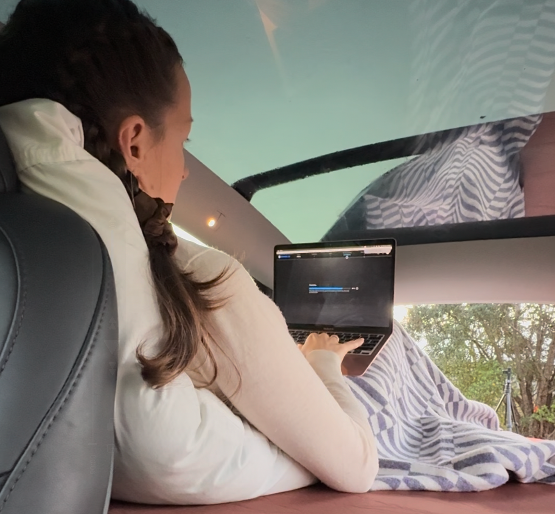 Tesla Model Y parked with Teraglide platform used as mobile office and bed