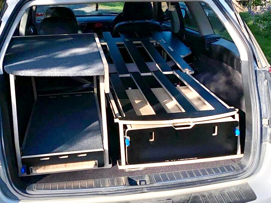 Subaru SUV with Teraglide car-camping platform installed in the trunk for flat sleep and organised gear storage