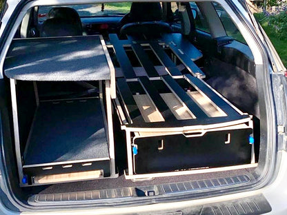 Subaru SUV with Teraglide car-camping platform installed in the trunk for flat sleep and organised gear storage