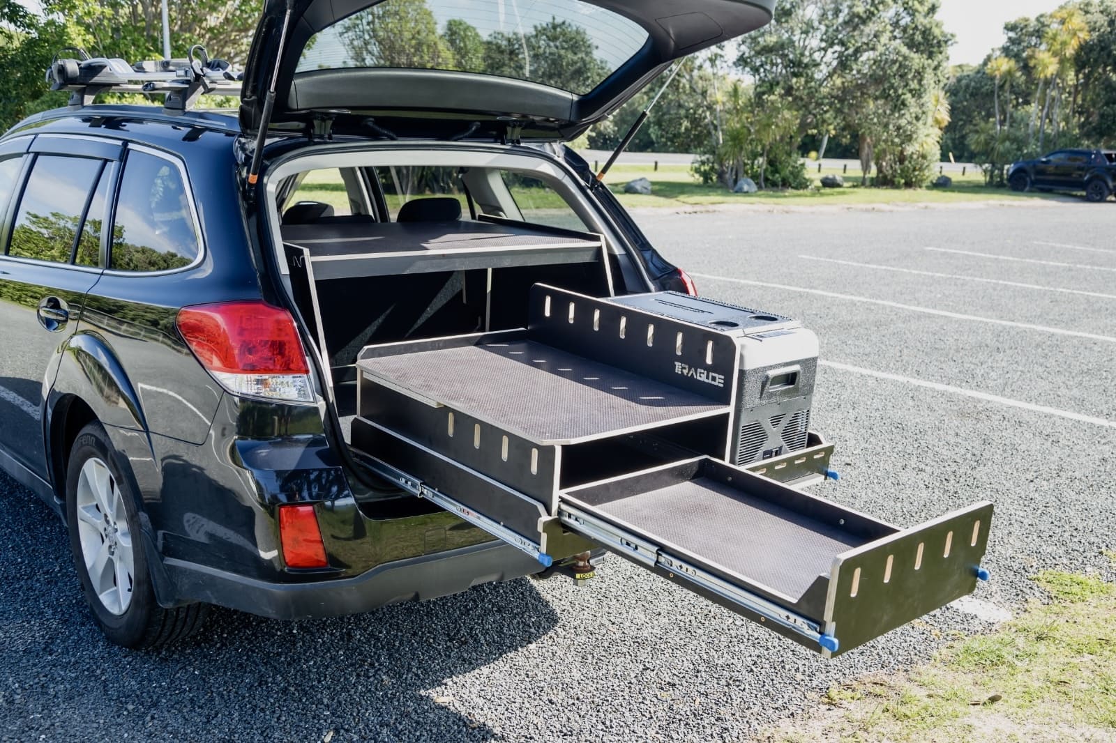 SUV car-camping platform setup by Teraglide with foldable bed and storage drawers ready for weekend travel