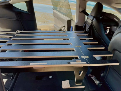 Tesla Model Y car-camping platform set up for sleeping inside the car, flat and secure