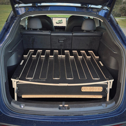 Interior view of the Teraglide PRO platform stowed in a Tesla Model Y with the rear seats upright