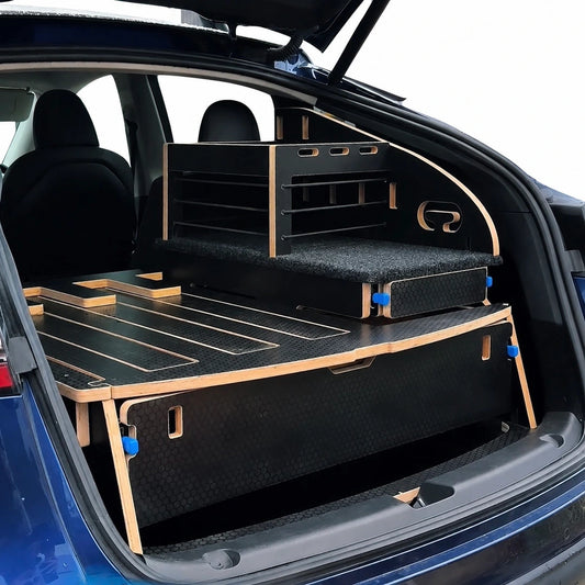 Teraglide SOLO car camping platform installed in a Tesla Model Y, showing a single sleeping platform with organised storage and kitchen module.