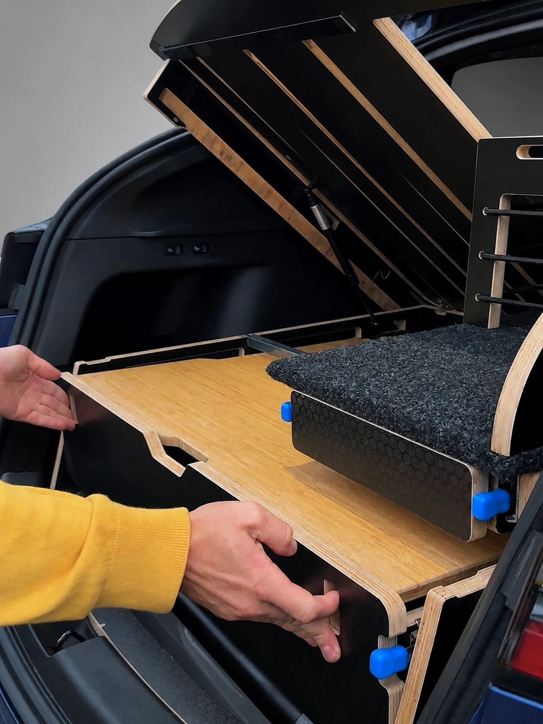 Teraglide SOLO platform lifted to provide quick access to the Tesla Model Y subtrunk and stored gear.