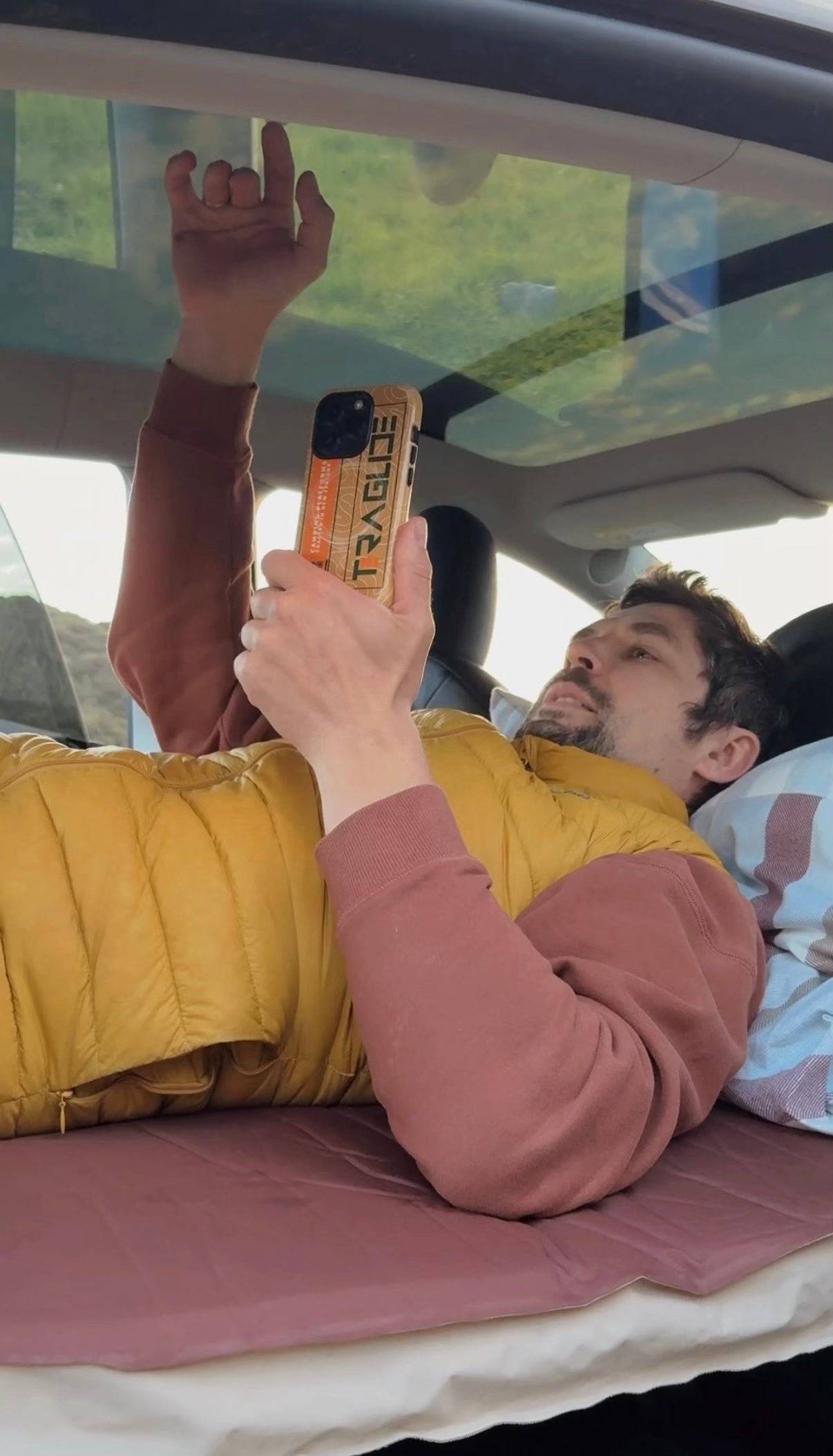 Man working comfortably inside a car on a fully flat Teraglide platform — stable surface for rest or remote work