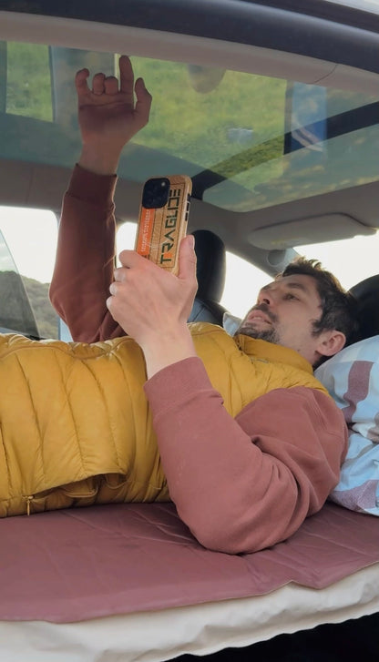 Man working comfortably inside a car on a fully flat Teraglide platform — stable surface for rest or remote work